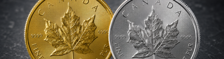 Close-up of a gold and a silver Canadian Maple Leaf investment coin side by side, showing detailed leaf design.